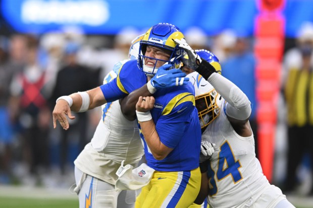 Rams quarterback Derion Kendrick, #11, gets pressure from Chargers Amen Ogbongbemiga, #57, and Chris Rumph II, #94, during first quarter action in the first pre-season game at SoFi Stadium Saturday, August 12, 2023. (Photo by David Crane, Los Angeles Daily News/SCNG)