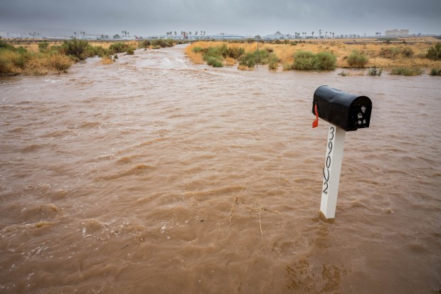A mailbox is submerged in water at Divison street and...