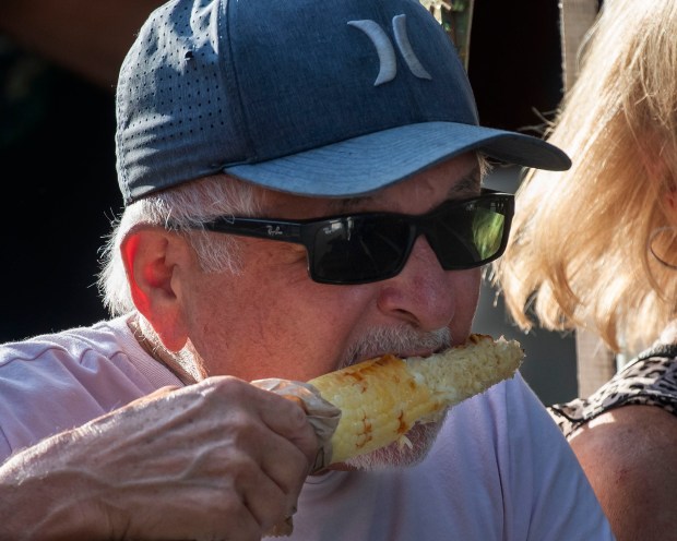 Pablo Esparza of Tustin enjoys a corn on the cob...