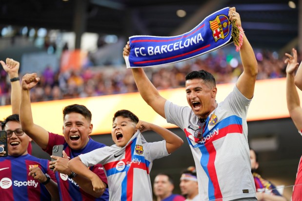 Fans cheer before a Champions Cup soccer match between FC Barcelona and Arsenal FC, Wednesday, July 26, 2023, in Inglewood, Calif. (AP Photo/Ashley Landis)