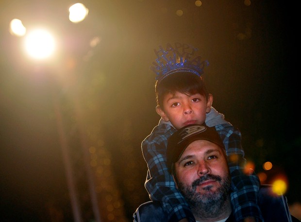Tim Carroll and his son Timmy, 5, take in the...